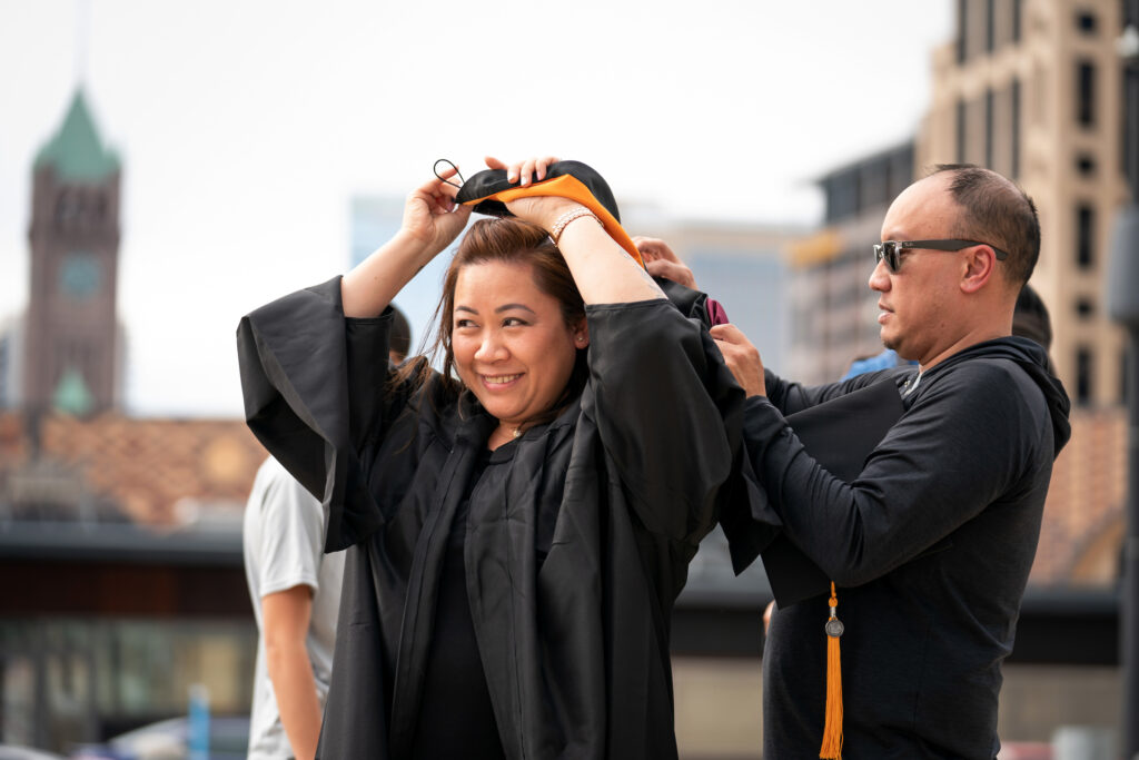 Student in regalia celebrating Commencement